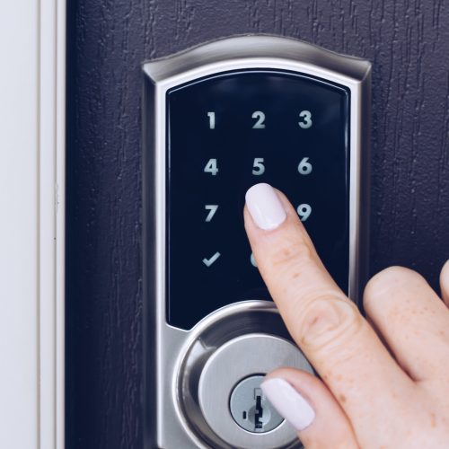 woman-s-hand-is-pressing-numbers-on-an-electronic-keypad-to-open-the-door-of-a-house.jpg